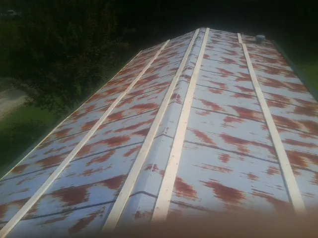 Rusted metal roof panels with new wood purlins before replacement — Storm Damage Roof Repair in Richmond Dale by Roofing Brothers