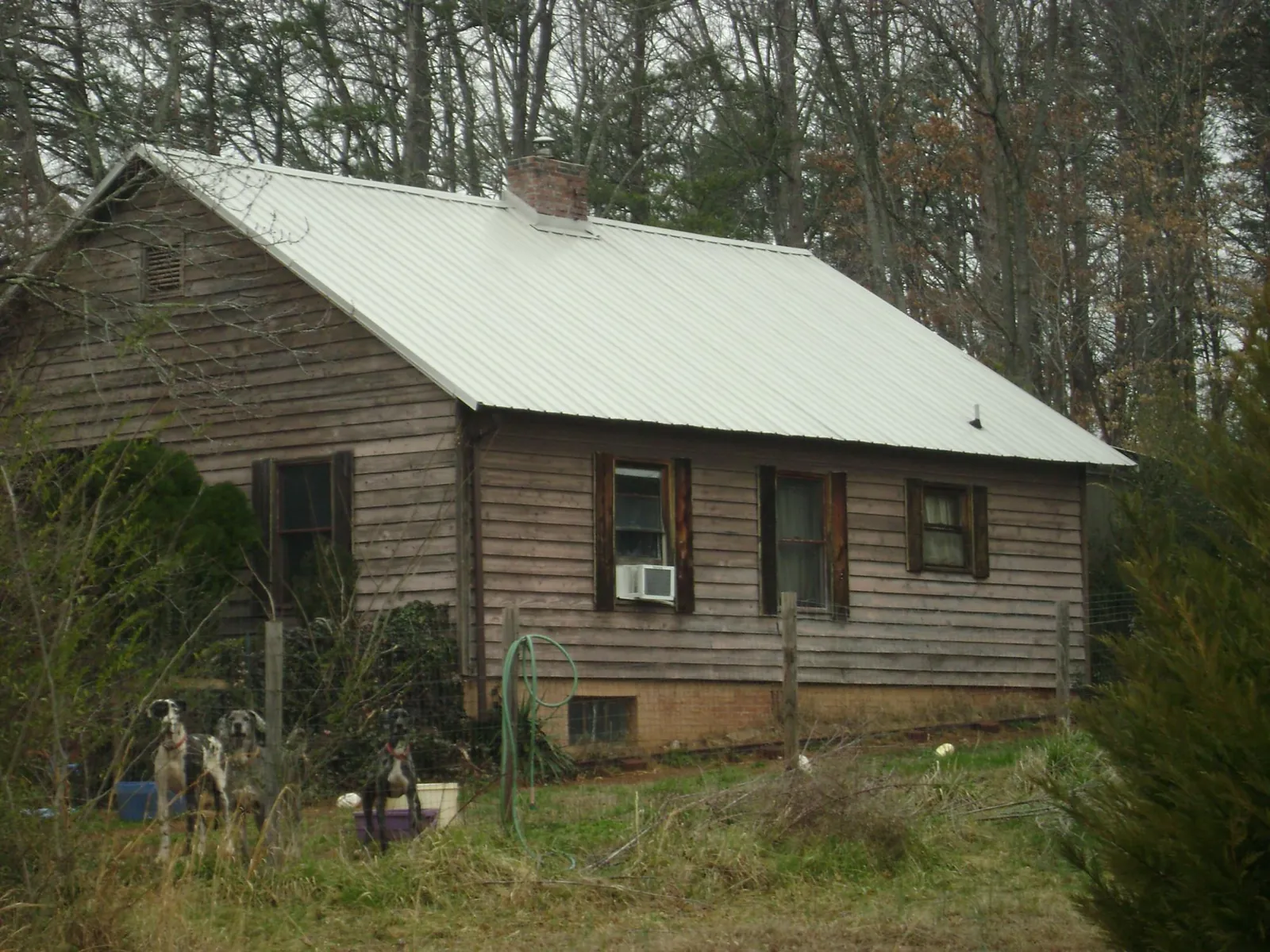 White metal roof on an old wood sided farmhouse, from a Metal Roof Installation job in Richmond Dale